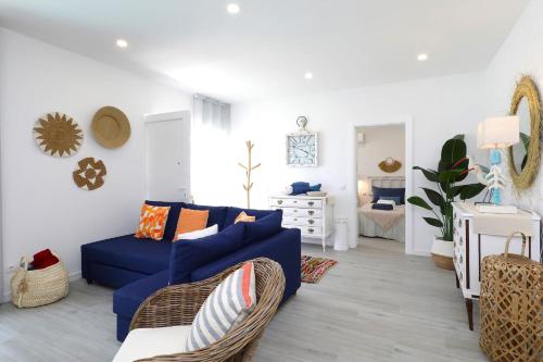 a living room with a blue couch and a bedroom at Casa Titi-stunning Holiday Home With Private Pool in Tavira