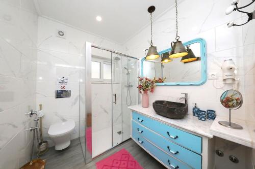 a bathroom with a sink and a toilet and a mirror at Casa Titi-stunning Holiday Home With Private Pool in Tavira