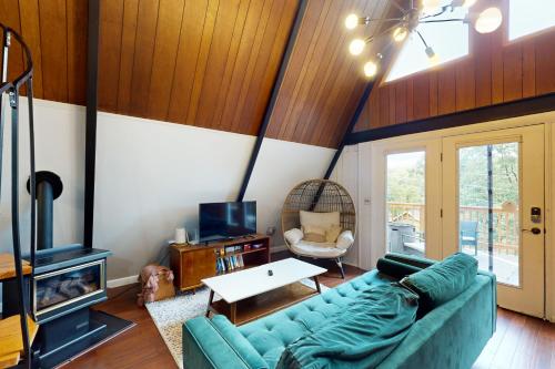 a living room with a blue couch and a fireplace at The Lost Haus in Garfield