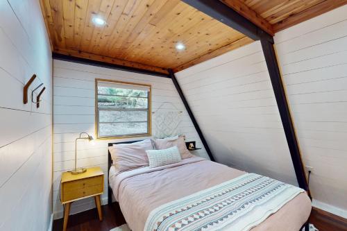 a bedroom in a tiny house with a bed at The Lost Haus in Garfield