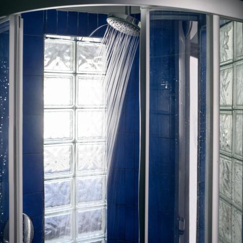 a blue shower curtain in front of a window at Afroditi Venus Beach Resort in Kamari