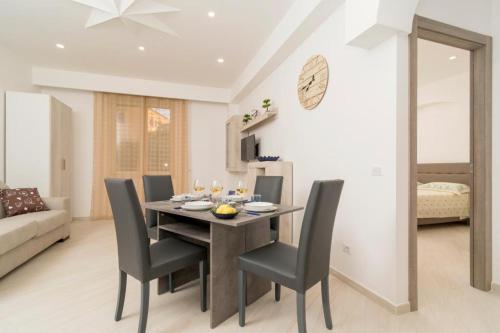 a dining room with a table and chairs at Carpe Diem Holiday House in Massa Lubrense