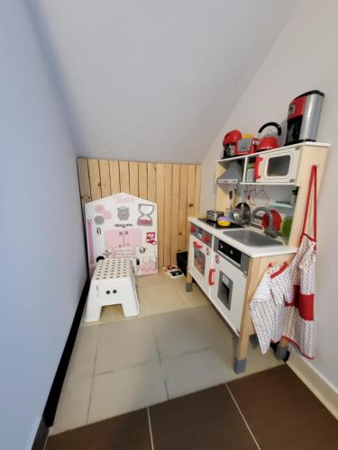 a small kitchen with a toy stove and a sink at Podkowa in Myślenice