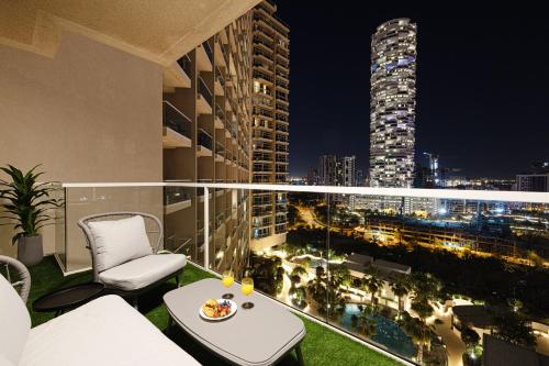 a balcony with a view of a city at night at SmartStay at Zaya Hameni - Modern Luxury Apartments - Unique in JVC in Dubai