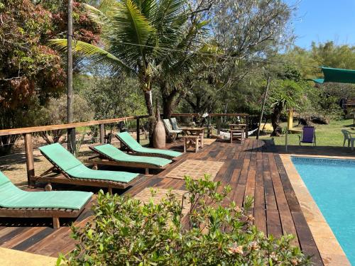 a group of lounge chairs next to a swimming pool at Hospedagem Fazenda Nova América in Brotas