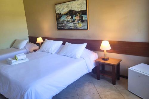 a hotel room with two beds and two lamps at Itu Garden - SPA e Resort Saudavel in Itu