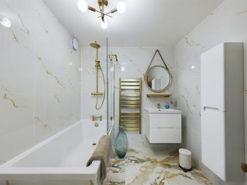 a bathroom with a sink and a mirror at Islington Lux garden flat moments to tube in London