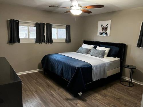 a bedroom with a bed and a ceiling fan at Modern 3 Bedroom Ranch House in Newark