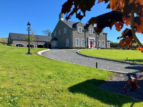 a large house with a winding road in front at Gelilah House in Loughbrickland
