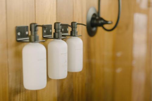 a group of three bottles hanging on a wall at Premium Floating Bungalow by Stay Ombi in Key Largo