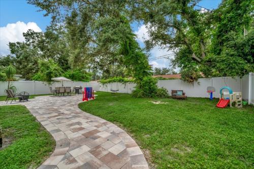 a yard with a patio and a playground at The Bardmoor a Luxury Family Retreat in St Pete in Seminole