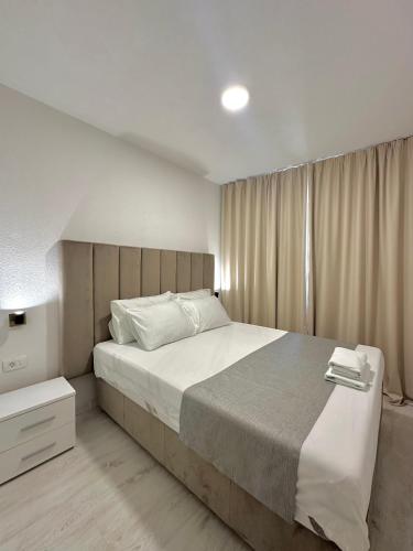 a bedroom with a large bed and a window at Apartments Sea Side in Petrovac na Moru