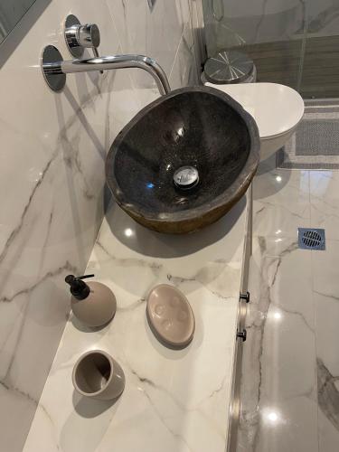 a bathroom with a black sink on a marble counter at Polis Villa Rethymnon , Crete in Kálivos