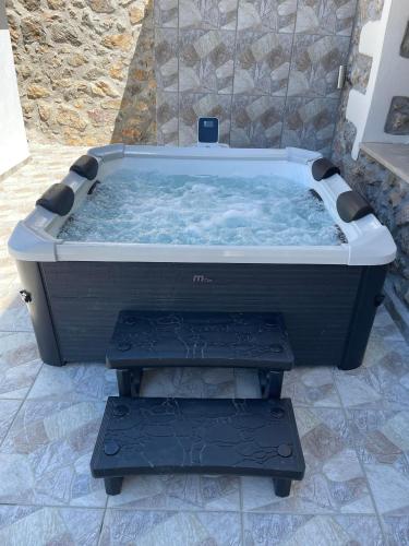 a large hot tub sitting on a tiled floor at Polis Villa Rethymnon , Crete in Kálivos