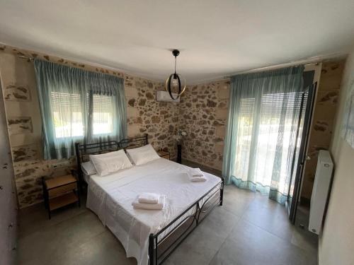 a bedroom with a bed with two towels on it at Polis Villa Rethymnon , Crete in Kálivos