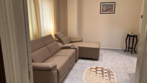 a living room with a couch and a chair at Hotel MEDINA in Oran
