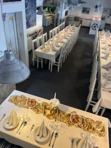 a row of tables in a restaurant with plates and glasses at Brasserka in Nitra