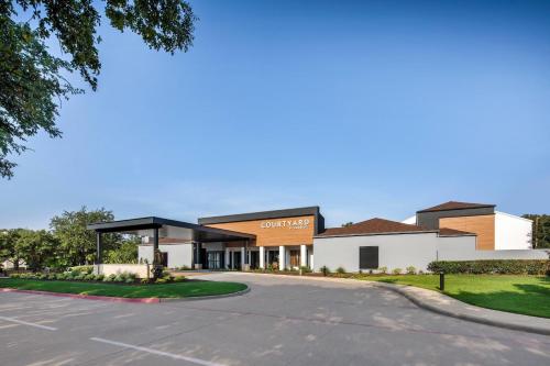 a rendering of the front of the office building at Courtyard Dallas Addison Midway in Addison