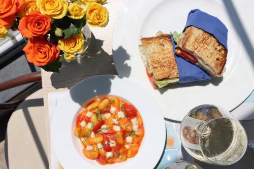 a table with two plates of food and a bowl of soup at Hotel Lord Byron in Ischia