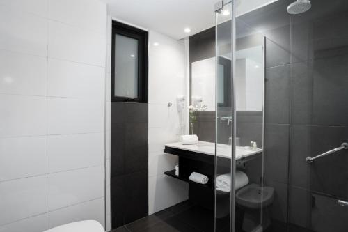 a bathroom with a toilet and a sink and a shower at Urbanica The Libertador Hotel in Buenos Aires
