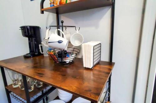 a wooden counter with utensils on top of it at Cozy Bungalow 10 Min to DTWN CLE in Euclid