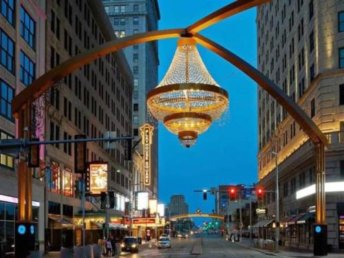 a large chandelier hanging over a city street at night at Cozy Bungalow 10 Min to DTWN CLE in Euclid
