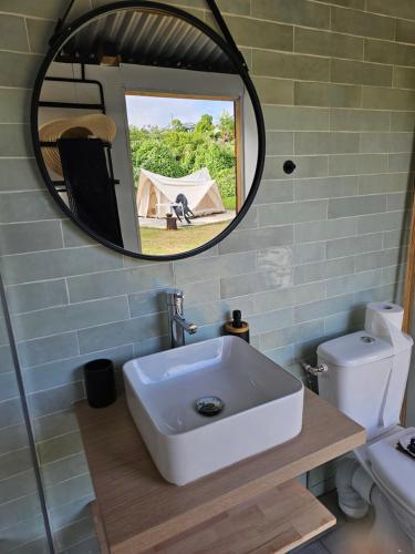 a bathroom with a sink and a mirror at Au coeur des plantations in La Possession