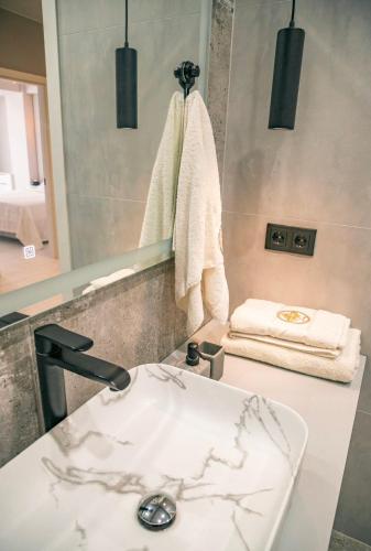 a bathroom with a sink and a mirror at Lux Apartament Center in Chişinău