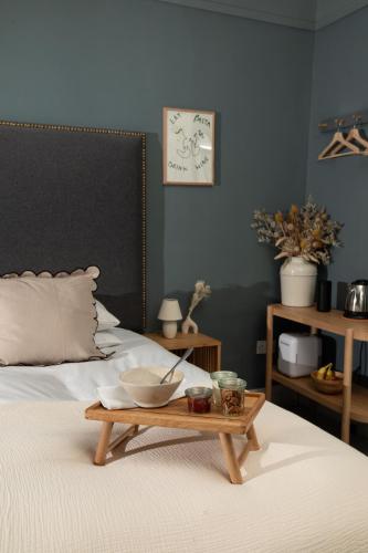 a room with a bed with a tray on it at Celentano's Restaurant with Rooms in Glasgow