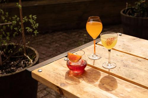 two glasses of wine sitting on a wooden table at Celentano's Restaurant with Rooms in Glasgow