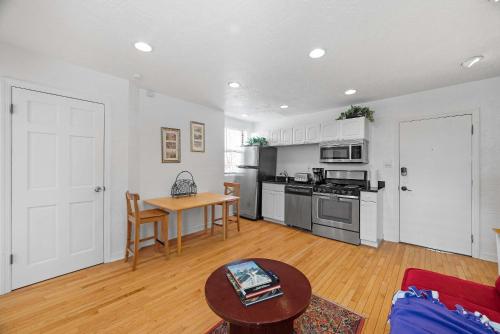 a living room with a table and a kitchen at Panoramic Views on Your Front Porch in Pittsburgh