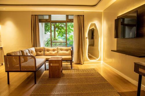 a living room with a couch and a table at Lion Villas in Nairobi
