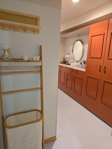 a bathroom with a sink and a red door at ueno minowa 602 in Tokyo