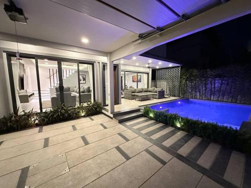 a house with a swimming pool in the backyard at Super Luxury 3 Bedroom Private Pool Villa with Jacuzzi, Near 711, 10 minutes to Walking Street and Pattaya Beach - MT6 in Pattaya