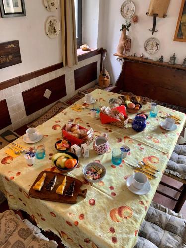 a table with food and drinks on top of it at Podere Pinzicalari in Castel del Piano