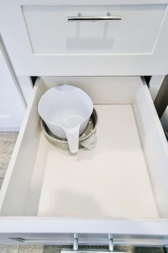 a white bowl in a drawer of a cabinet at Boho Revival Modern Glam with AC in Downtown Albany in Albany