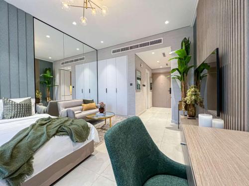 a bedroom with a bed and a living room at Bright New Studio with Pool & Gym Access, 5 min from Gardens Metro in Dubai