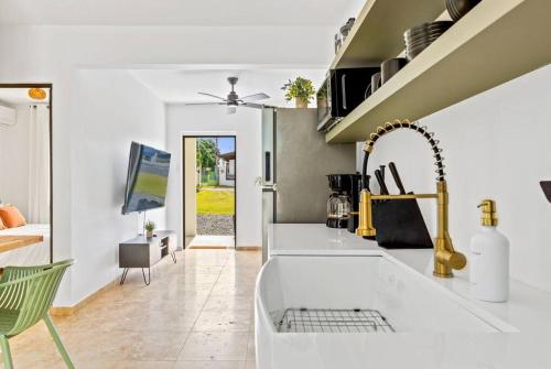 a kitchen with a sink and a counter top at Coralinas Beach Apartments in El Combate