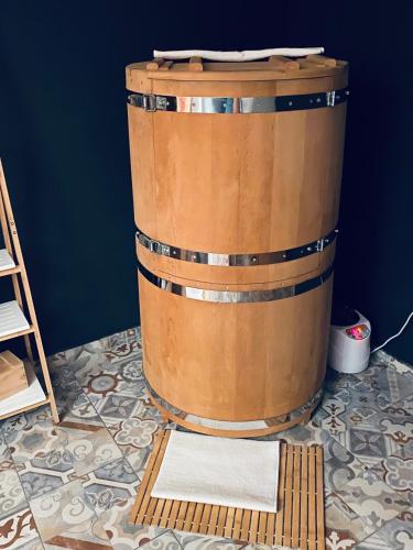 a large wooden barrel sitting on top of a floor at Rooms & Apartment ZALA in Cerklje na Gorenjskem