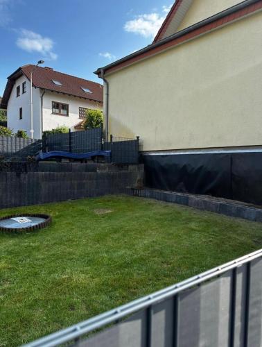 a yard with a fence next to a house at Casa Di Monaco in Glees