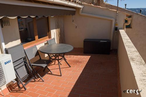 a table and chairs sitting on a brick patio at Casa Garí in Horta de San Joan