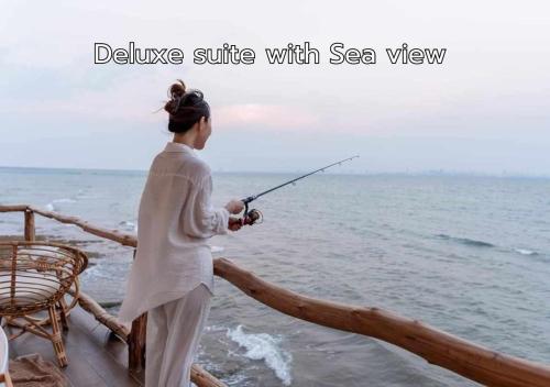 a woman fishing on a boat in the ocean at De' Ocean land เดอโอเชี่ยนแลนด์ เกาะล้าน in Ko Larn