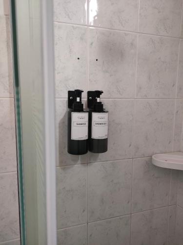 two bottles ofodorizers on a wall in a bathroom at Le Grazie in Popoli