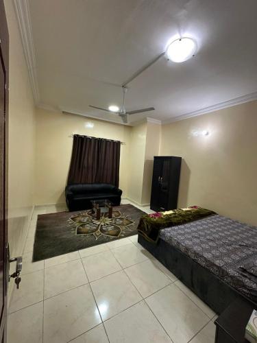 a room with a bed and a chair in it at Elegant Master Suite with Luxurious Compfort in Ajman 