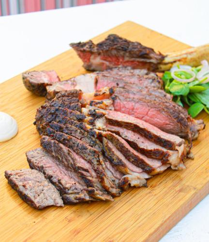 a piece of meat on a cutting board at Swissôtel Al Murooj Dubai in Dubai