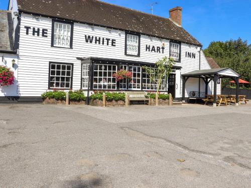 a white building with a white hair at White Hart Stables in Battle