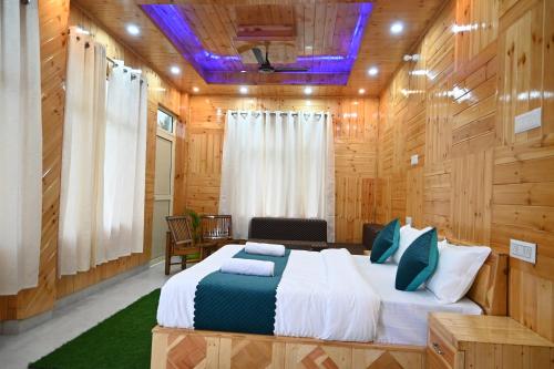 a bedroom with a bed in a room with wooden walls at A Frame cottage sainj in Sainj