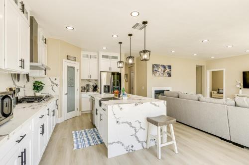 a kitchen and living room with white cabinets and a couch at Mtn-View Gem with Private Yard Luxe Beaumont Home in Beaumont