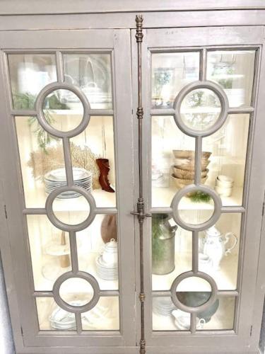 a glass cabinet with dishes inside of it at Historical Entertainer 3 Bedroom Townhouse AC PNW in Albany