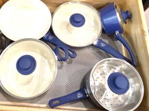 a wooden box with blue plastic utensils in it at Historical Entertainer 3 Bedroom Townhouse AC PNW in Albany